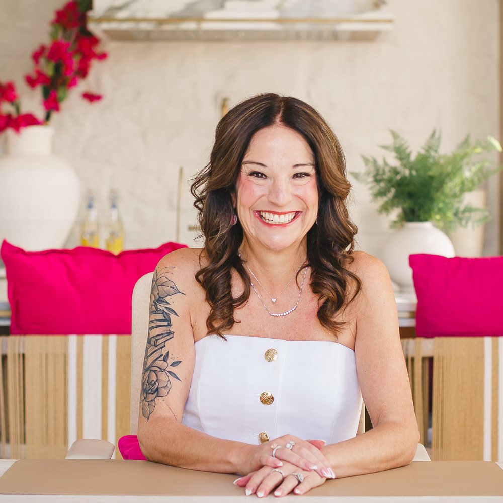 Jamie, founder of Not So Wimpy Teacher, smiling at her desk